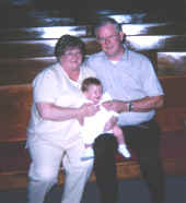 brittany leigh at her baptism 8 19 98 with her grammie and grampie.jpg (81913 bytes)