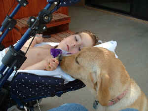 Sadie and Samantha Smelling the flower 5.18.03 005resized.jpg (60580 bytes)